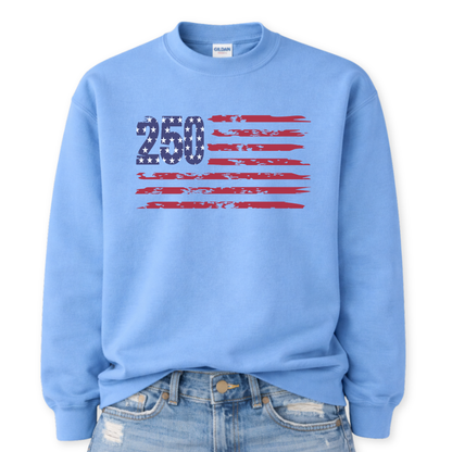 Gildan Carolina Blue crewneck sweatshirt mockup with a front tuck into distressed denim, featuring a bold “250” star-filled graphic with distressed red flag stripes forming a patriotic American flag design.