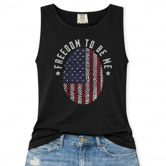 Black tank top with 'Freedom to be Me' and American flag design, worn with blue jeans on a white background.