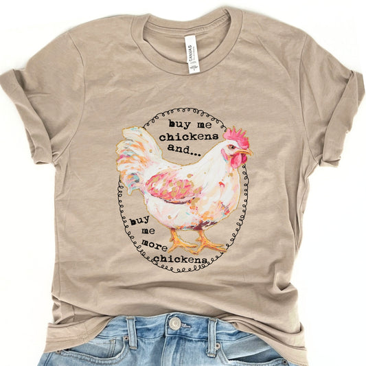 Buy me chickens and buy me more chickens on a heather tan bella canvas tshirt featuring a white chicken