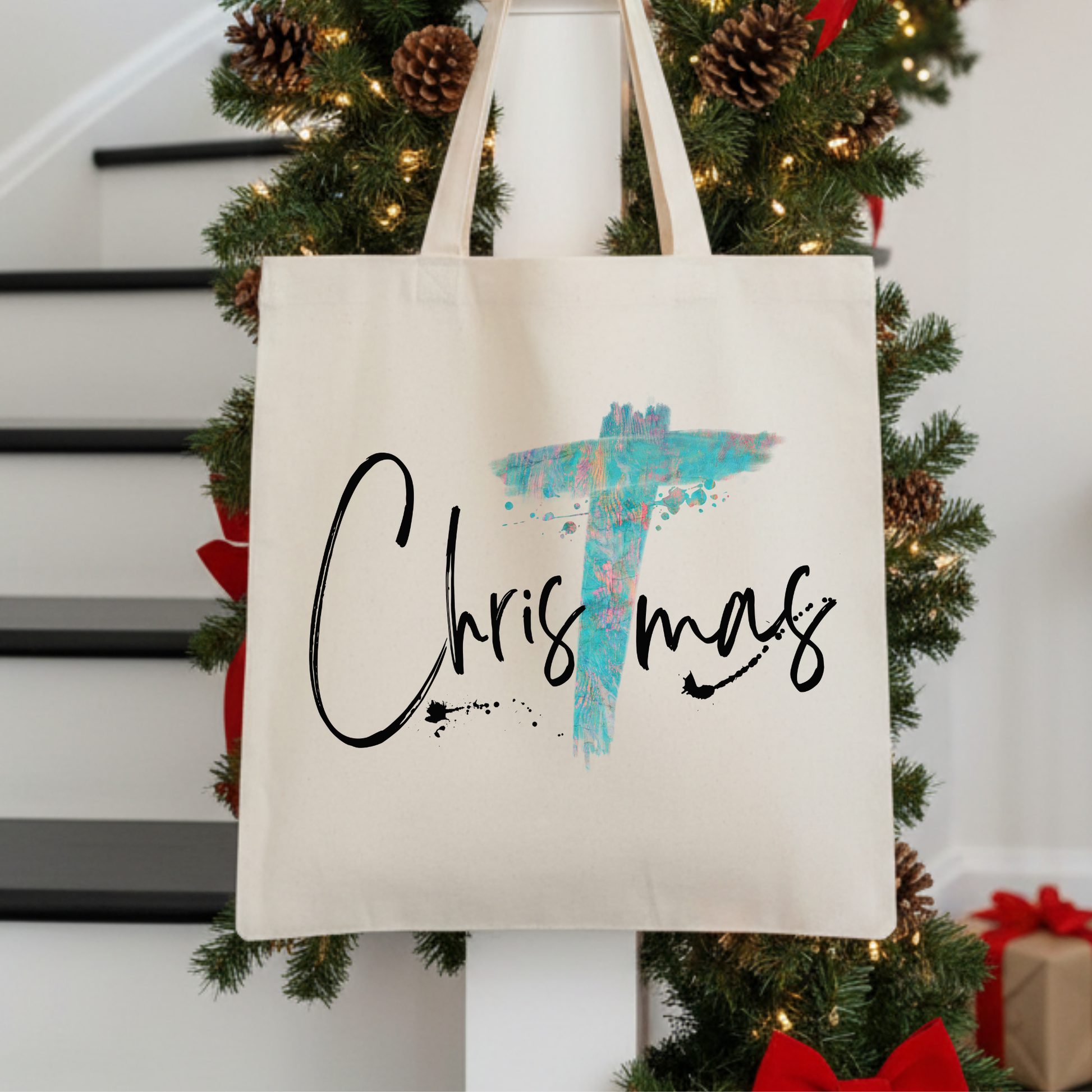 tote bag that says Christmas.  The T in Christmas is a large Christian Cross