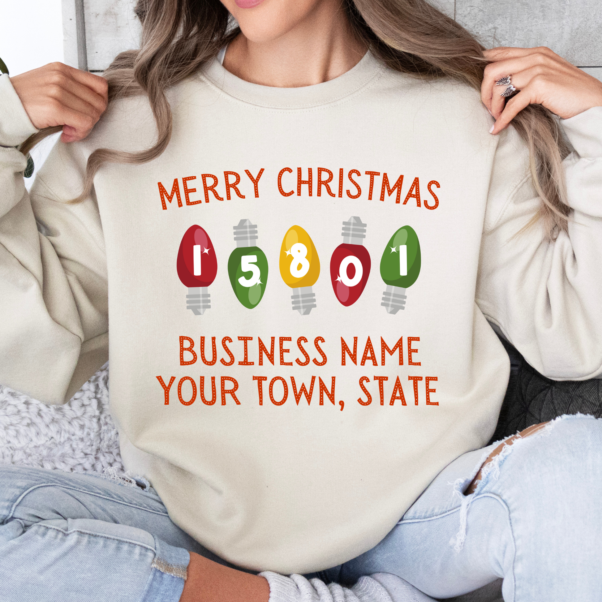 Merry Christmas customizable sand color sweatshirt with business name, city and state or both.  zipcode is in the Christmas tree light bulbs