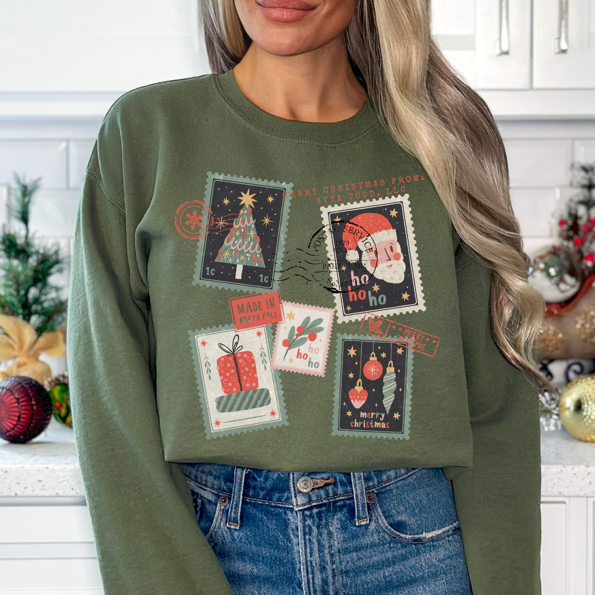 Christmas stamps scattered across a military green sweatshirt.  Customize with your town, state, business, or all.