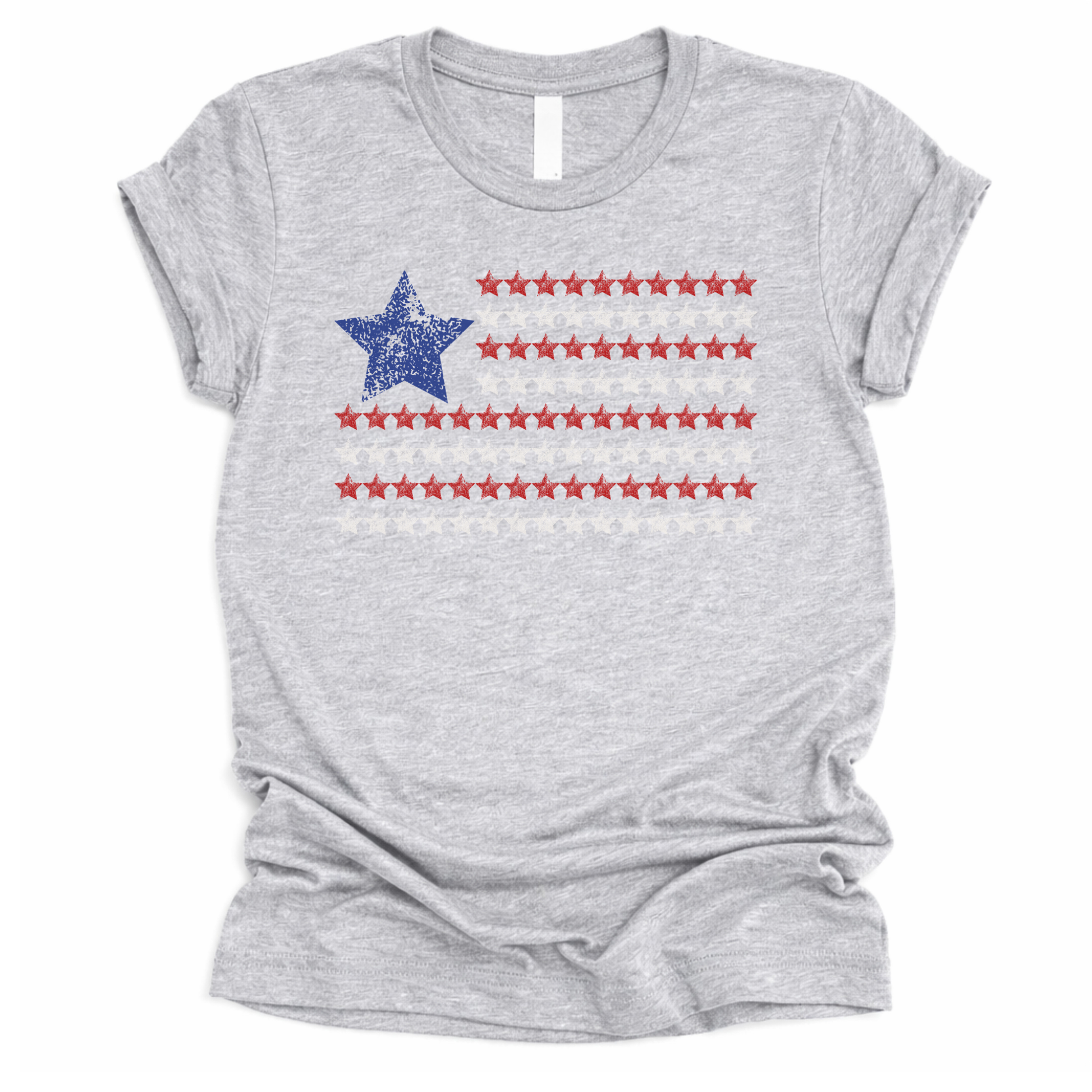 Patriotic Americana flag graphic on a gray t-shirt. The design features a distressed blue star positioned at the top left, paired with horizontal rows of red stars forming a flag-inspired layout. Soft weathered textures give the graphic a vintage, worn-in look while keeping the overall style clean and modern. The simple star-based flag design makes this an easy, everyday patriotic piece for Fourth of July, summer holidays, and Americana-themed collections.