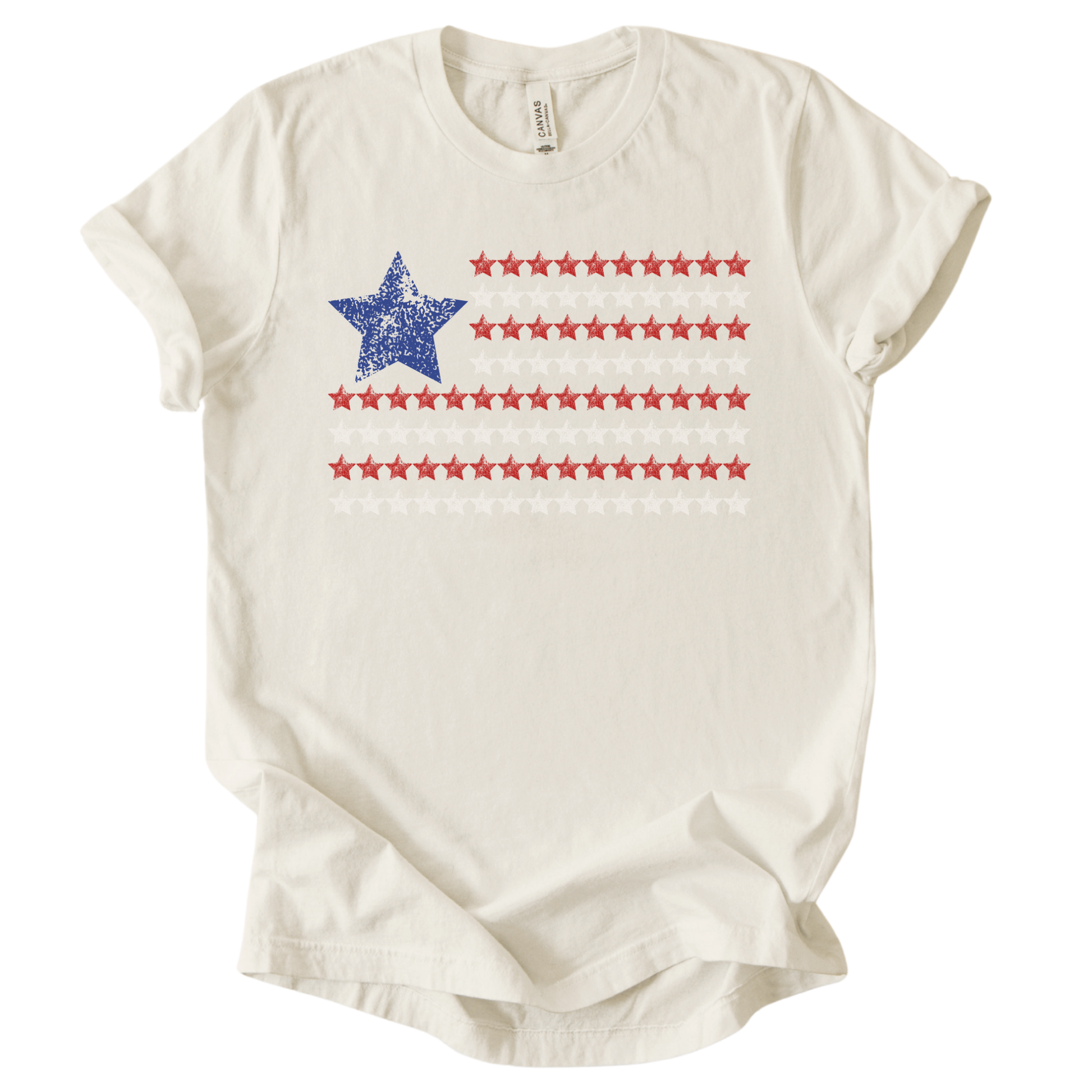 Patriotic Americana flag graphic on a cream t-shirt. The design features a distressed blue star positioned at the top left, paired with horizontal rows of red stars forming a flag-inspired layout. Soft weathered textures give the graphic a vintage, worn-in look while keeping the overall style clean and modern. The simple star-based flag design makes this an easy, everyday patriotic piece for Fourth of July, summer holidays, and Americana-themed collections.