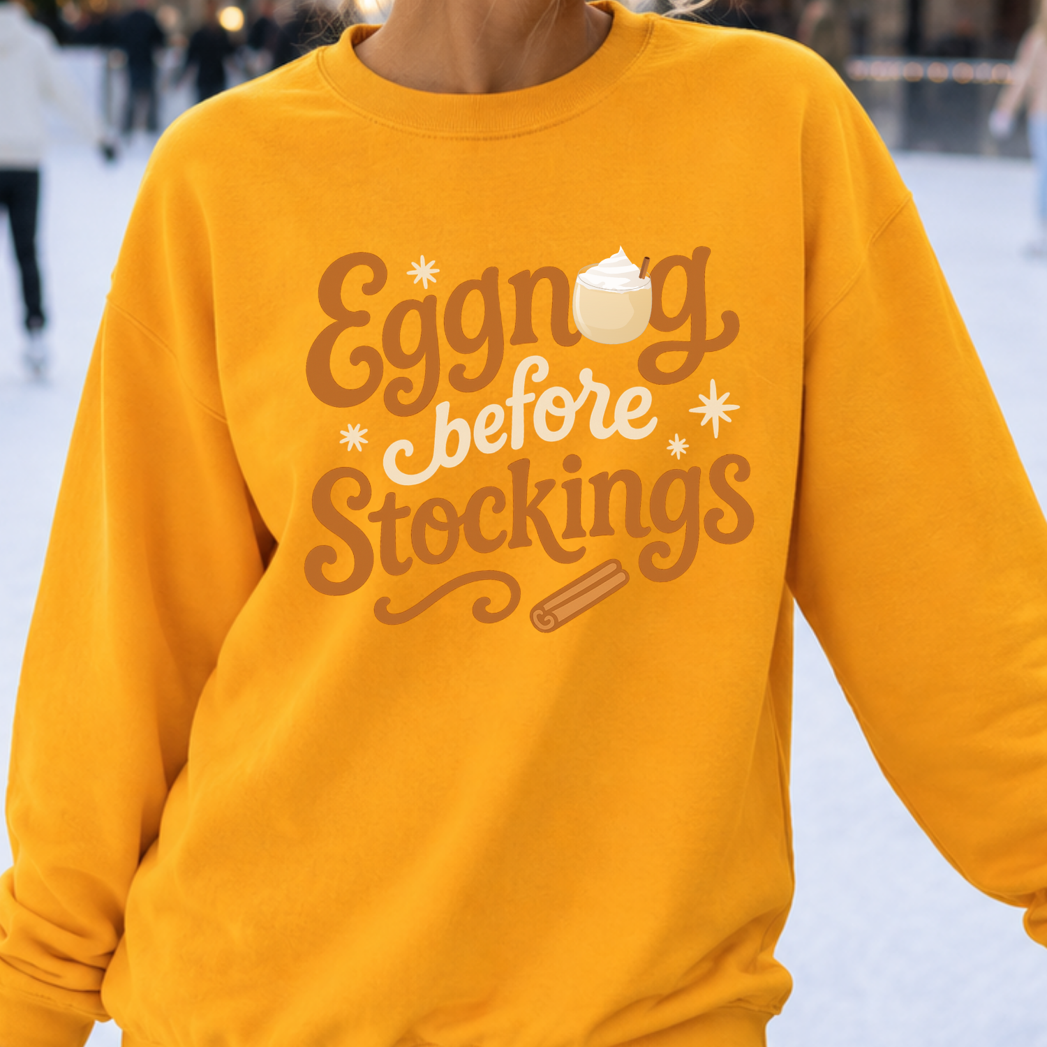 Eggnog Before Stockings Funny Christmas Graphic on a gold Sweatshirt