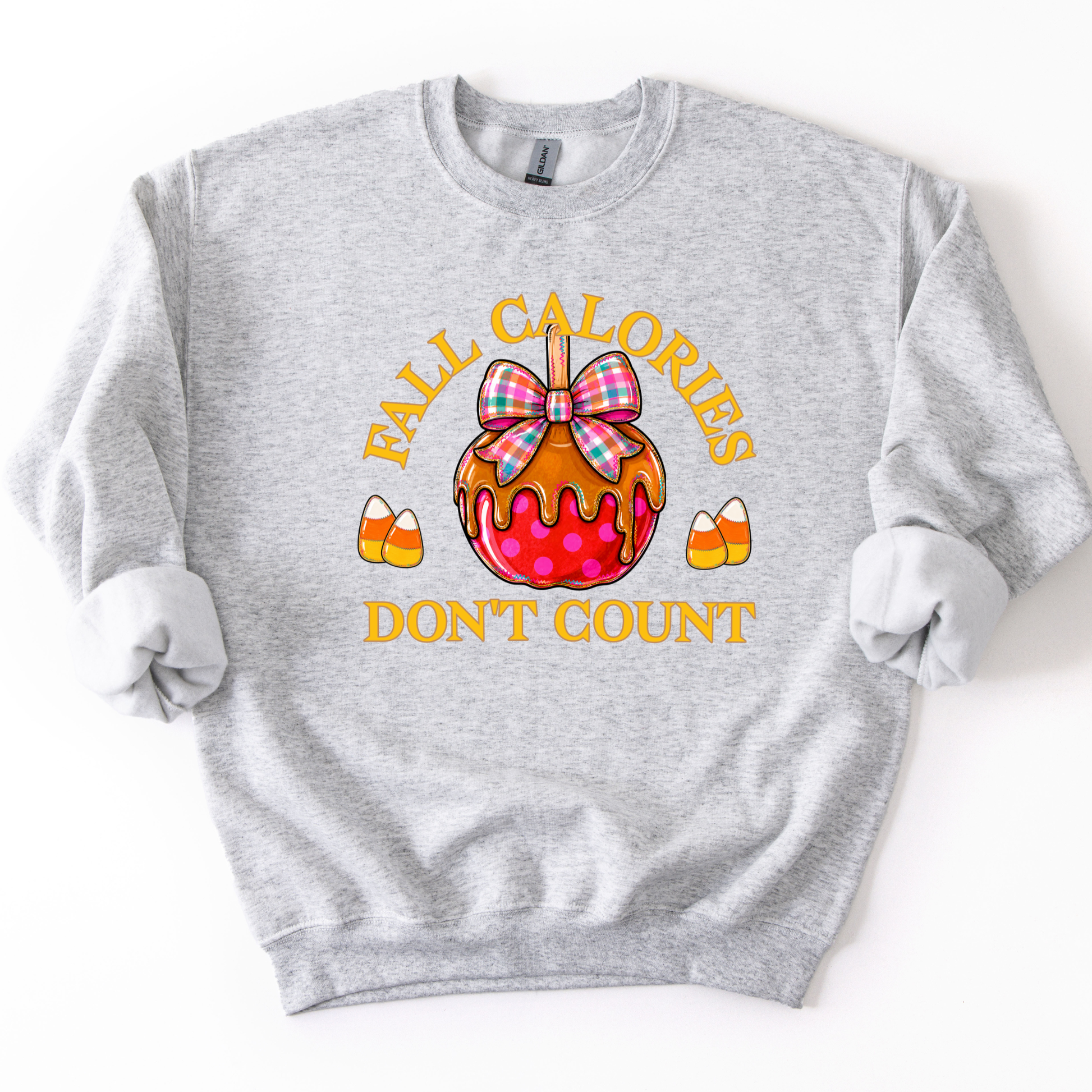 Fall calories don't count featuring a cute candy apple with a fall plaid ribbon. Cute little candy corns accent the sides of the large candy apple. Ash gray sweatshirt