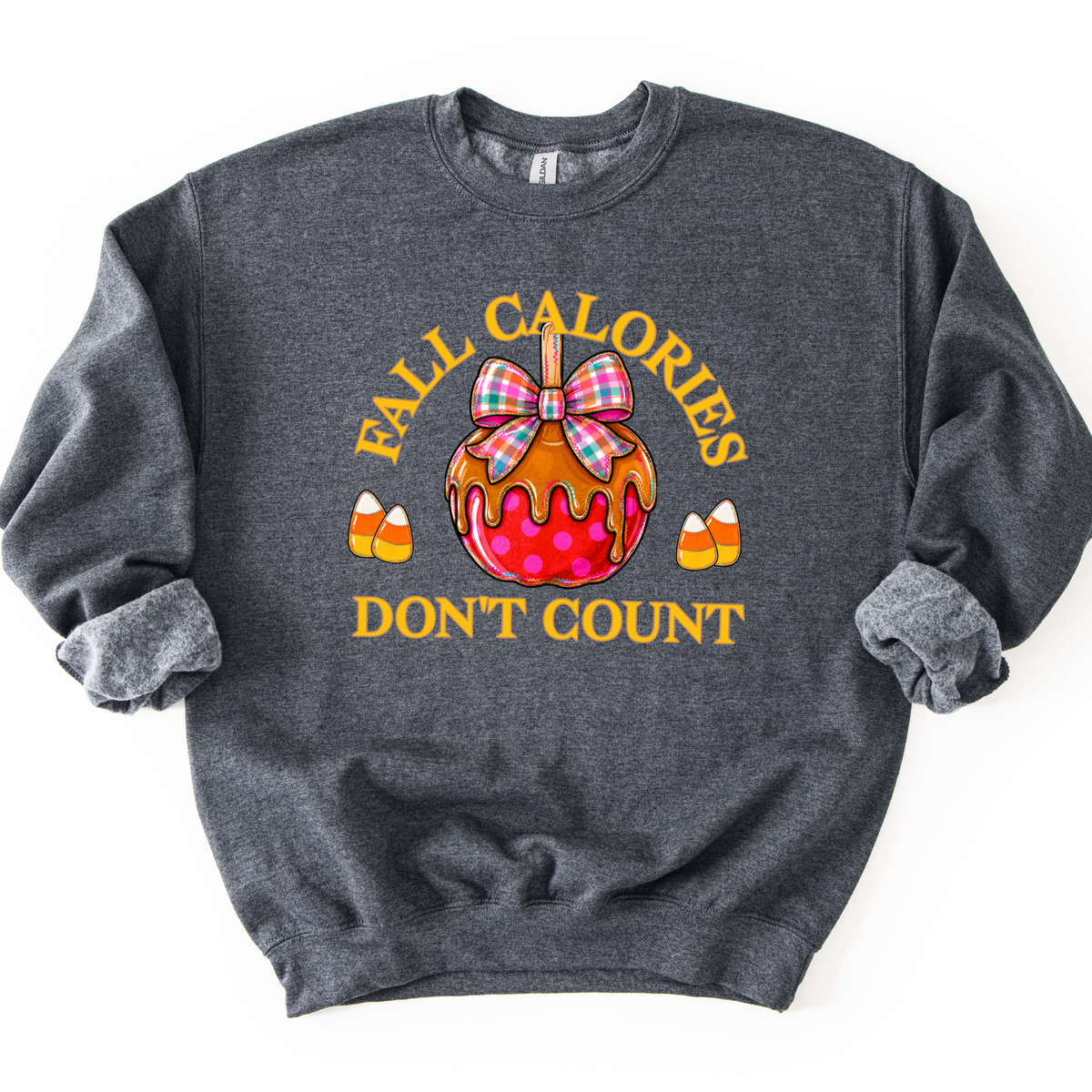 Fall calories don't count featuring a cute candy apple with a fall plaid ribbon. Cute little candy corns accent the sides of the large candy apple. Dark heather sweatshirt