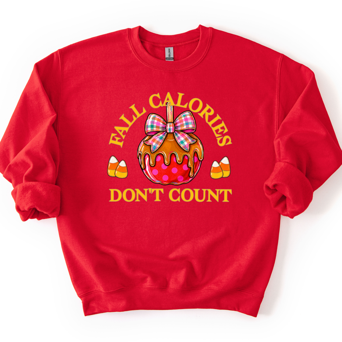 Fall calories don't count featuring a cute candy apple with a fall plaid ribbon. Cute little candy corns accent the sides of the large candy apple. Red sweatshirt