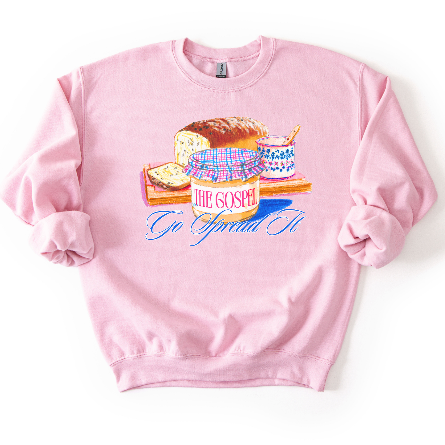 Pink sweatshirt with a graphic desing of bread and peanut butter.  the graphic says Go spread it and "The Gospel" on the peanut butter