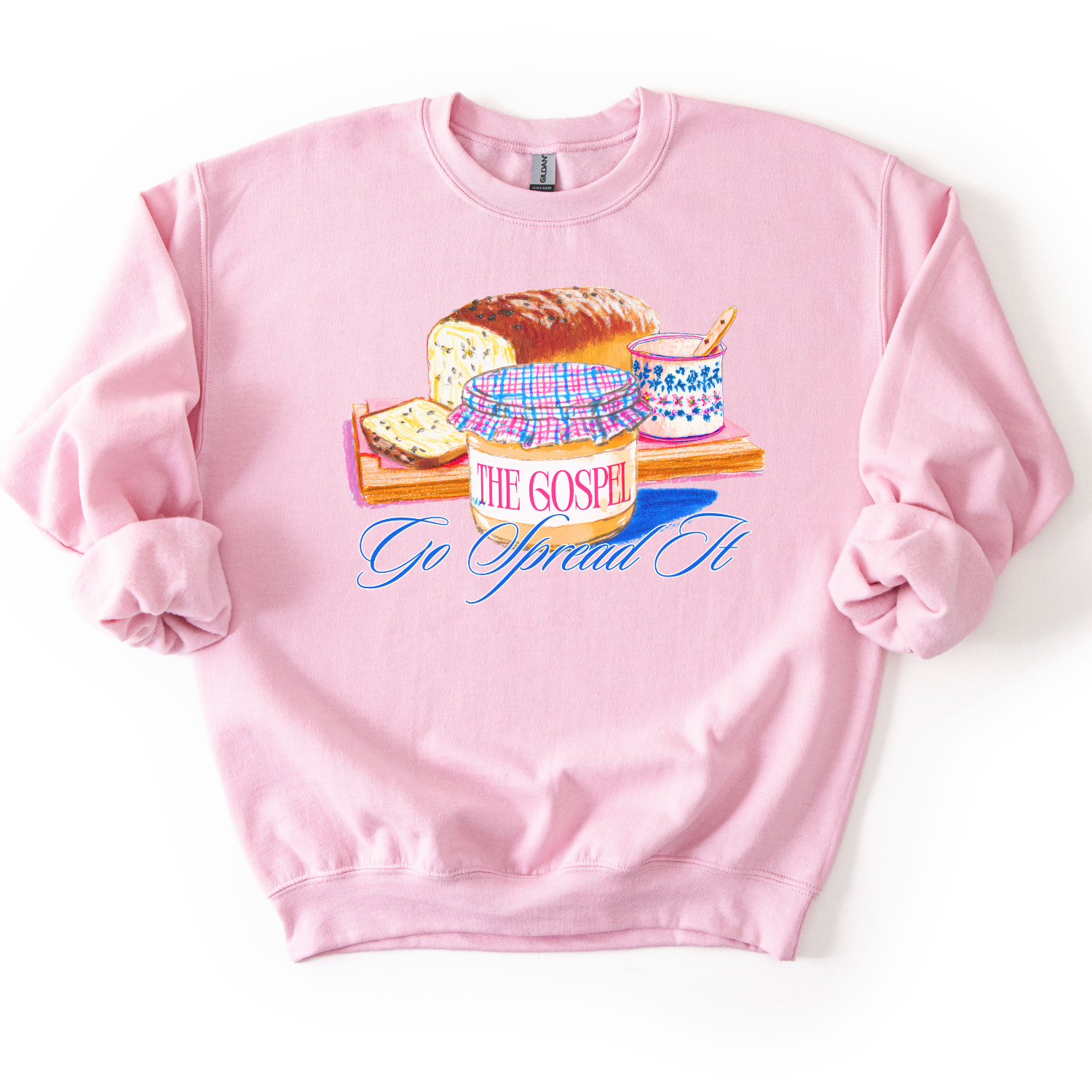 Pink sweatshirt with a graphic desing of bread and peanut butter.  the graphic says Go spread it and "The Gospel" on the peanut butter