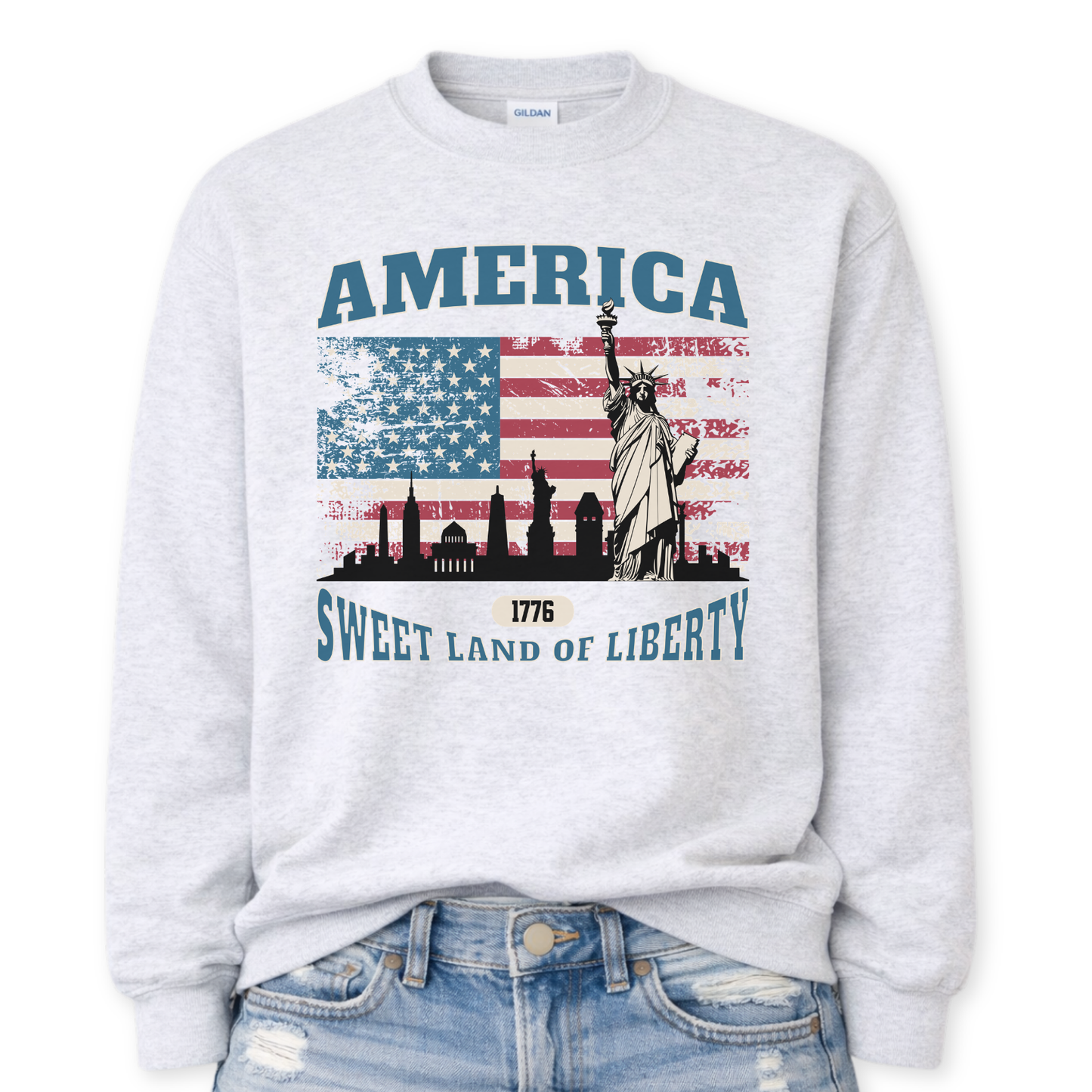 ash gray sweatshirt with American flag and Statue of Liberty design on a white background.  America, 1776 Sweet Land Of Liberty saying