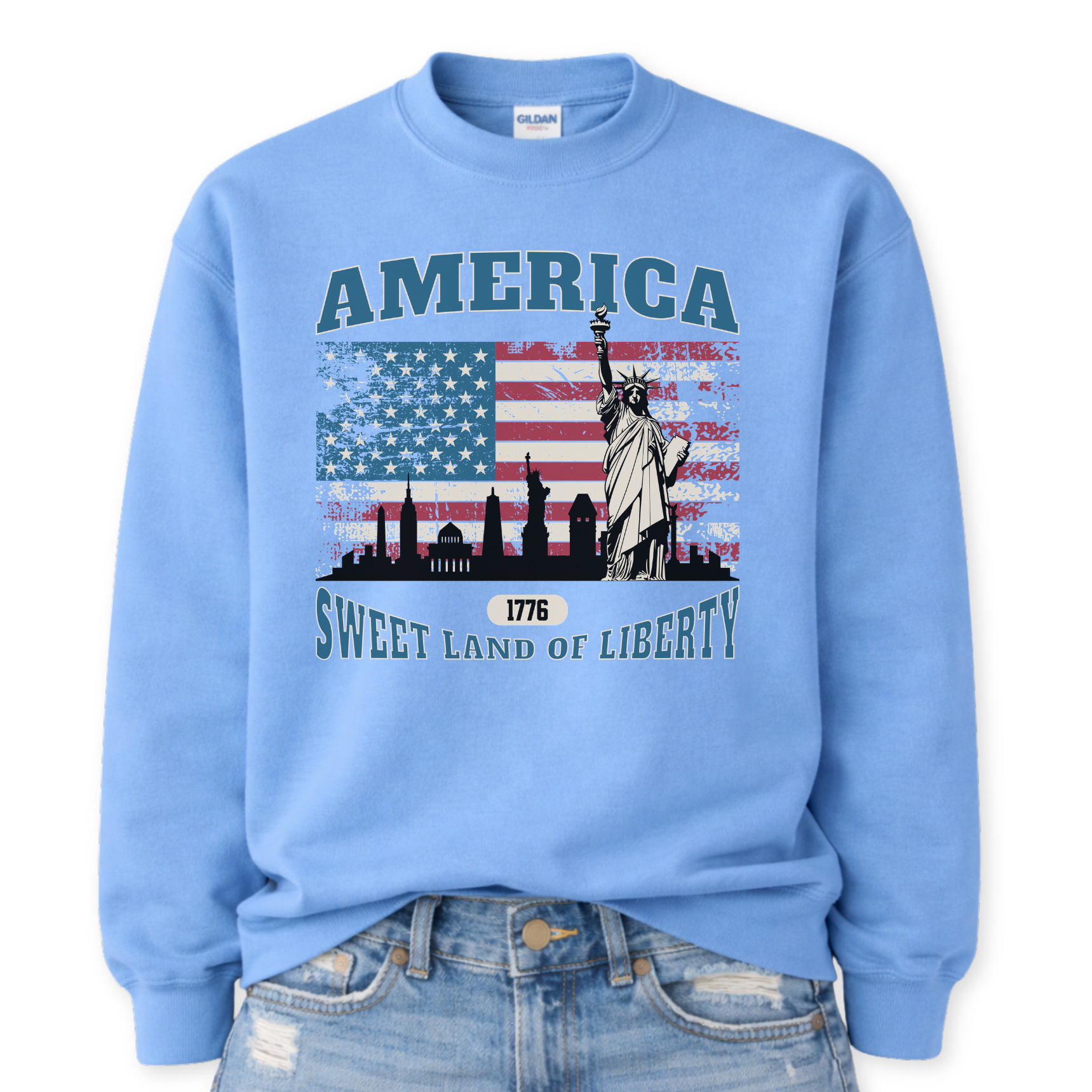 blue sweatshirt with American flag and Statue of Liberty design on a white background.  America, 1776 Sweet Land Of Liberty saying