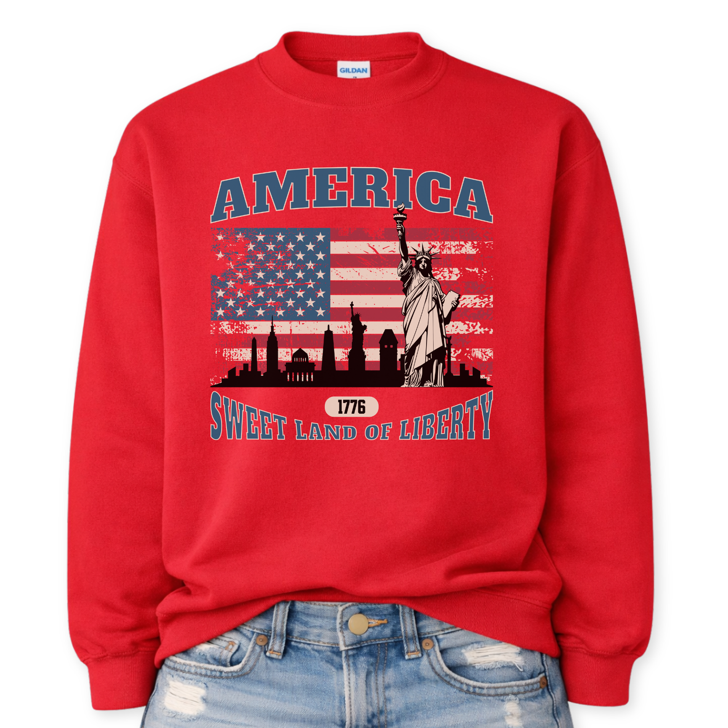 Red sweatshirt with 'America Sweet Land of Liberty' design featuring the Statue of Liberty and American flag.