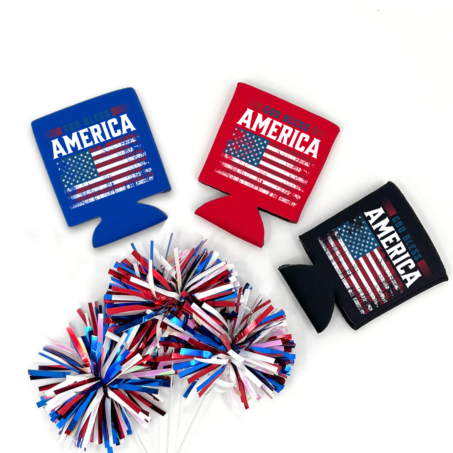 Red, blue and black collapsible can cooler displayed on a white background with a red, white, and blue metallic pom pom in the foreground. The graphic features the phrase “God Bless America” above a distressed American flag graphic. Patriotic red, white, and blue design printed on the front of the drink sleeve style can cooler.