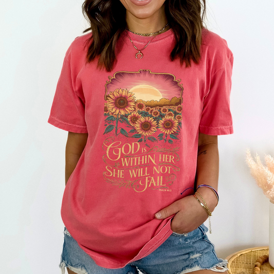 Person wearing a pink t-shirt with a sunflower design and text.  God is within her, She will not Fail Psalm 46:5