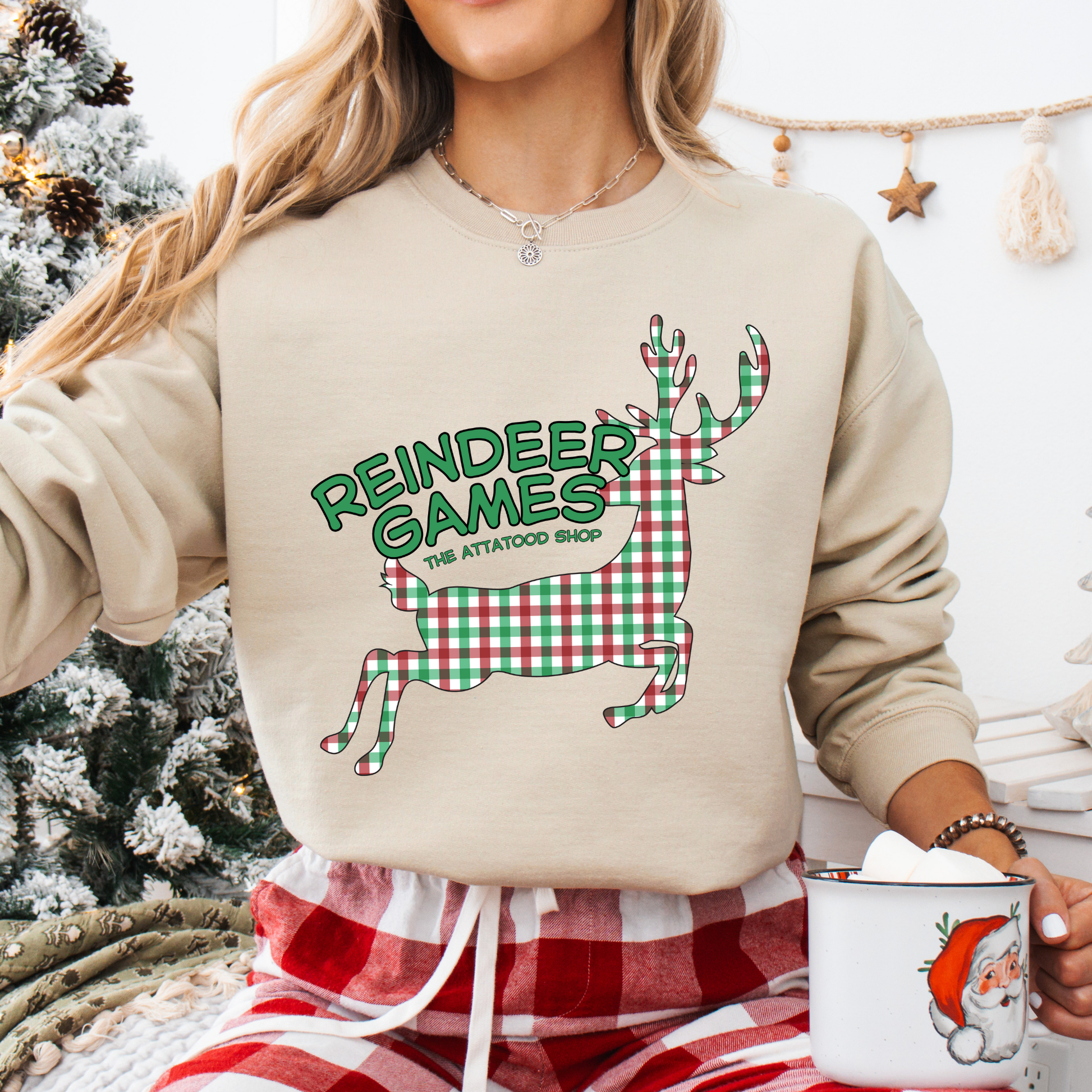 beige sweatshirt with a plaid reindeer.  Test says reindeer games.  You can customize the sweatshirt with business name, town and state or both