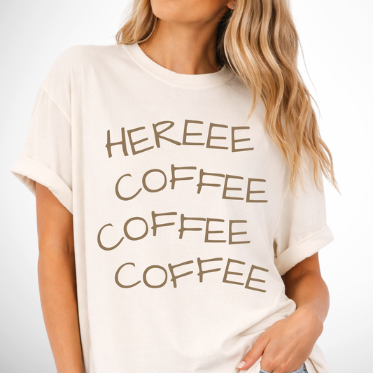 Person wearing a white t-shirt with 'HEREEE COFFEE COFFEE COFFEE' text.
