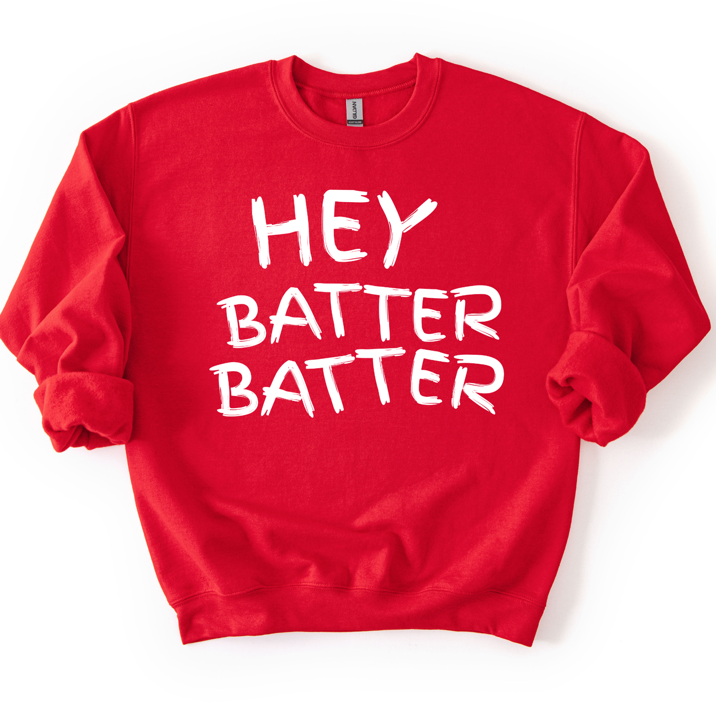 red crewneck sweatshirt with white hand-drawn style lettering reading “Hey Batter Batter,” styled flat with sleeves scrunched