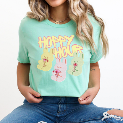Heather Mint Playful Easter graphic on a Bella Canvas t-shirt. The design features a relaxed pink bunny illustration paired with the bold phrase “Hoppy and Unbothered” in modern, oversized lettering. The artwork blends trendy humor with soft seasonal styling, making it a fun spring statement piece.