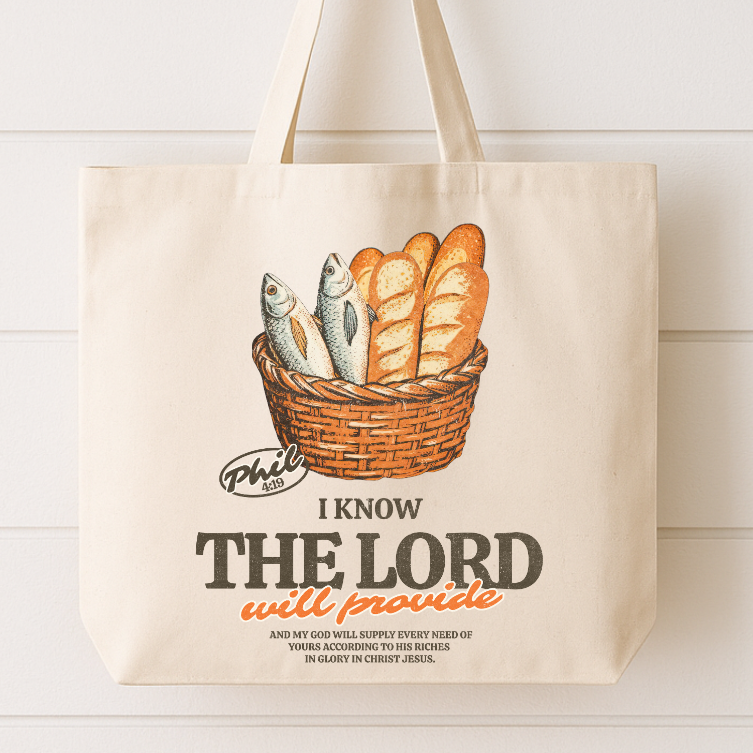 Tote bag with a basket of bread and fish design and Bible verse text. I know the Lord will provide