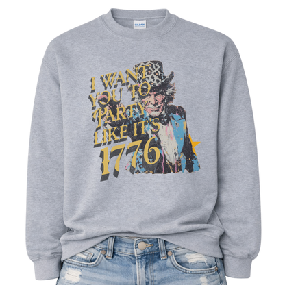Patriotic Uncle Sam graphic on a gray sweatshirt. The design features a distressed illustrated portrait of Uncle Sam wearing a patterned top hat, paired with bold vintage-style text reading “I Want You to Party Like It’s 1776.” Layered textures, muted patriotic tones, and worn ink details give the artwork a retro Americana feel. A bold, playful patriotic design suited for Fourth of July, summer celebrations, and USA-themed seasonal collections.