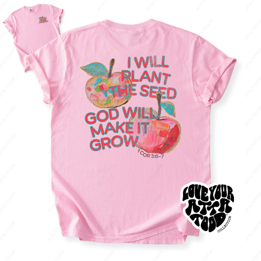 Apple-themed teacher graphic with faith message “I Will Plant the Seed God Will Make It Grow,” statement imagery with painted texture look, printed on a Comfort Colors® garment-dyed tee.