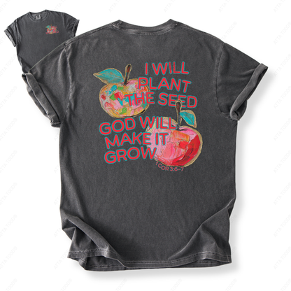 Apple-themed teacher graphic with faith message “I Will Plant the Seed God Will Make It Grow,” statement imagery with painted texture look, printed on a Comfort Colors® garment-dyed tee.
