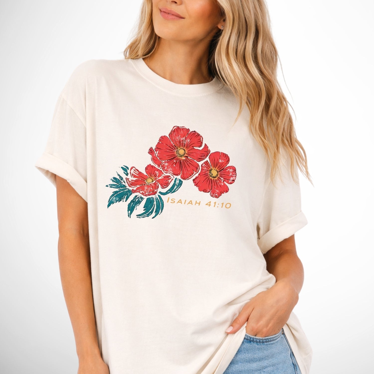 Woman wearing a white t-shirt with red floral design and text on a plain background. Isaiah 41:10 Red Poppy Flowers Graphic Comfort Colors Tee