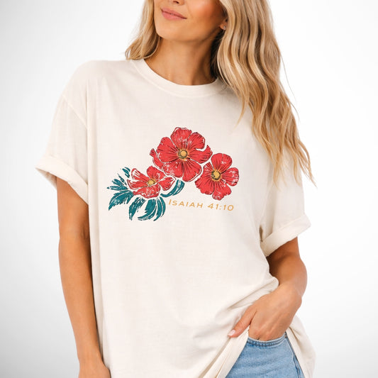Woman wearing a white t-shirt with red floral design and text on a plain background. Isaiah 41:10 Red Poppy Flowers Graphic Comfort Colors Tee