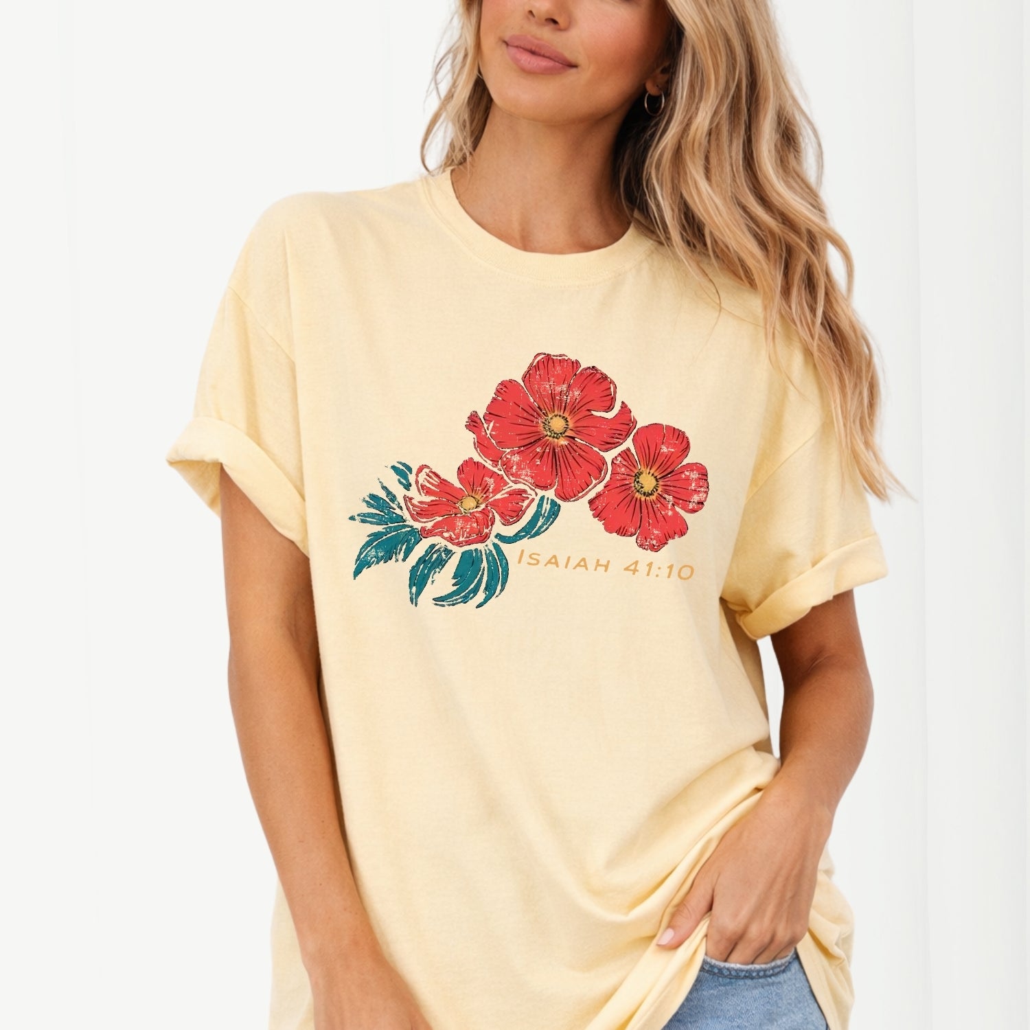 Woman wearing a yellow t-shirt with red floral design and text on a white background. Isaiah 41:10 Red Poppy Flowers Graphic Comfort Colors Tee