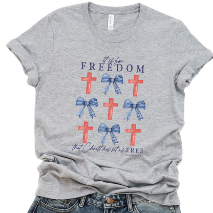 Gray t-shirt with red crosses and blue bows on a white background.  It is for Freedom that Christ has set us FREE.