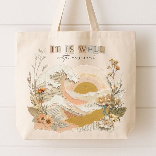 Tote bag with 'It is well with my soul' design featuring a sunset and floral elements on a white background.