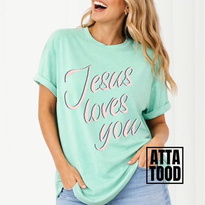 Person wearing a island reef green t-shirt with 'Jesus loves you' text, brand 'ATTA TOOD' visible. Jesus loves you