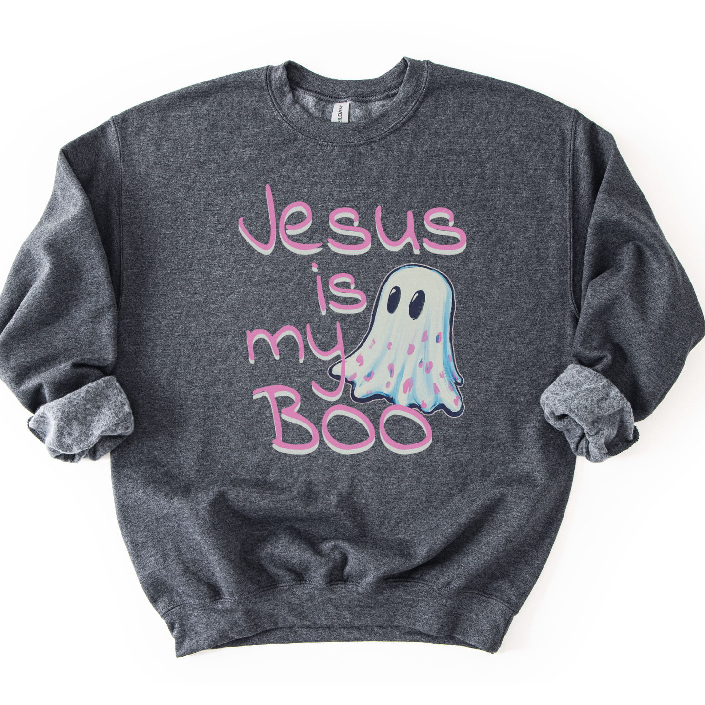 A dark heather gray crewneck sweatshirt featuring a graphic print that reads 'Jesus is my Boo' in pink script, accompanied by a cute pastel ghost illustration, laid flat on a white background.