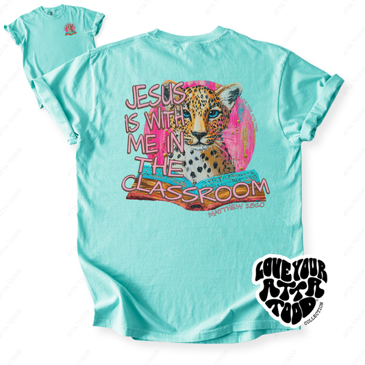 Faith-based teacher graphic with text “Jesus Is With Me in the Classroom,” high-contrast painted style artwork with intentional imperfection, printed on a Comfort Colors® tee.