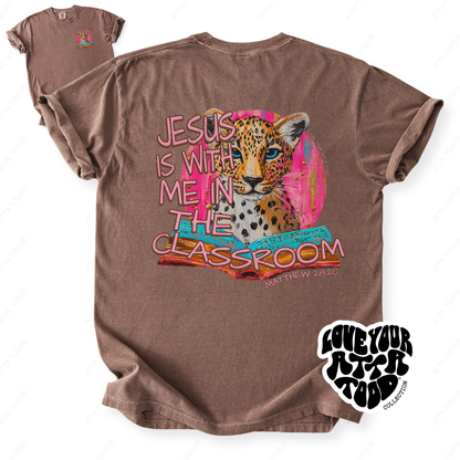 Faith-based teacher graphic with text “Jesus Is With Me in the Classroom,” high-contrast painted style artwork with intentional imperfection, printed on a Comfort Colors® tee.