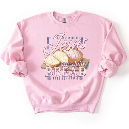 Light pink sweatshirt with 'Jesus my daily BREAD' text and bread graphic on a white background
