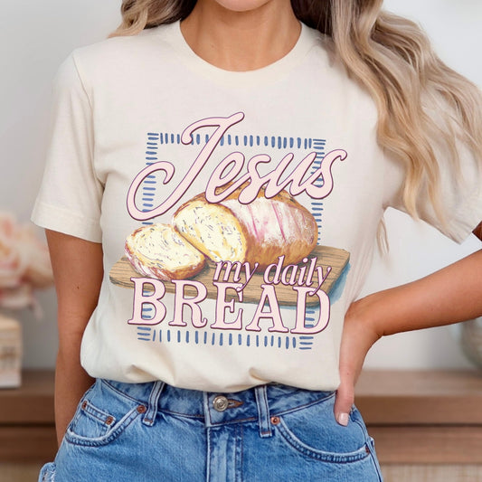 tan "Jesus My Daily Bread" featuring a wood cutting board with a loaf of bread graphic on a premium soft Bella Canvas Unisex tee.&nbsp;