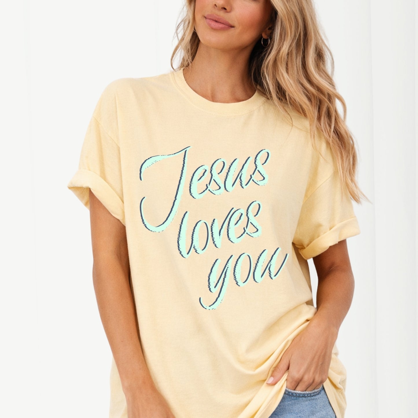 Woman wearing a yellow t-shirt with 'Jesus loves you' text on a white background