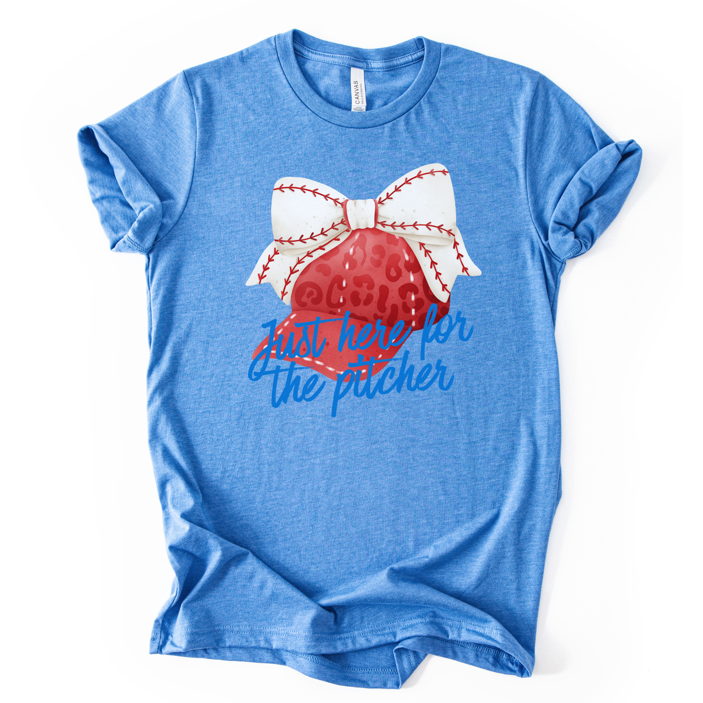 Blue t-shirt with a baseball and bow graphic and text on a white background.  the shirt says just here for the pitcher