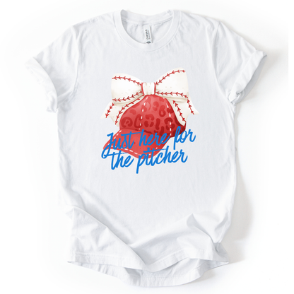 White t-shirt with a red baseball and blue text on a white background. Just here for the pitcher.  a white baseball ribbon is on the red hat