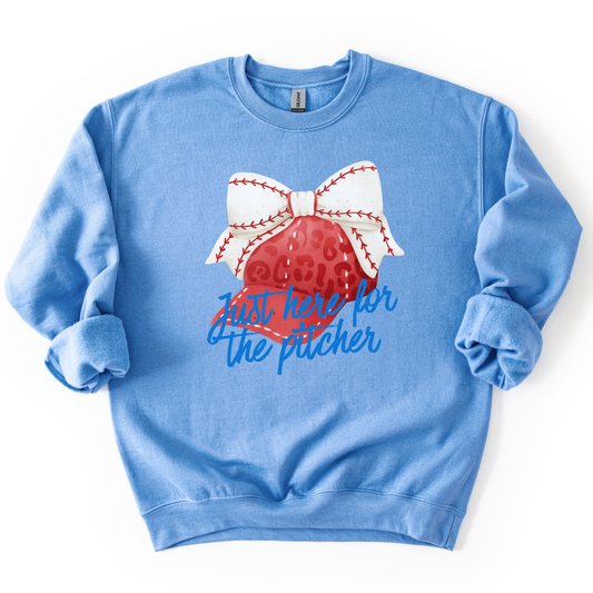 Blue sweatshirt with a baseball and softball graphic and text on a white background.  Just here for the pitcher