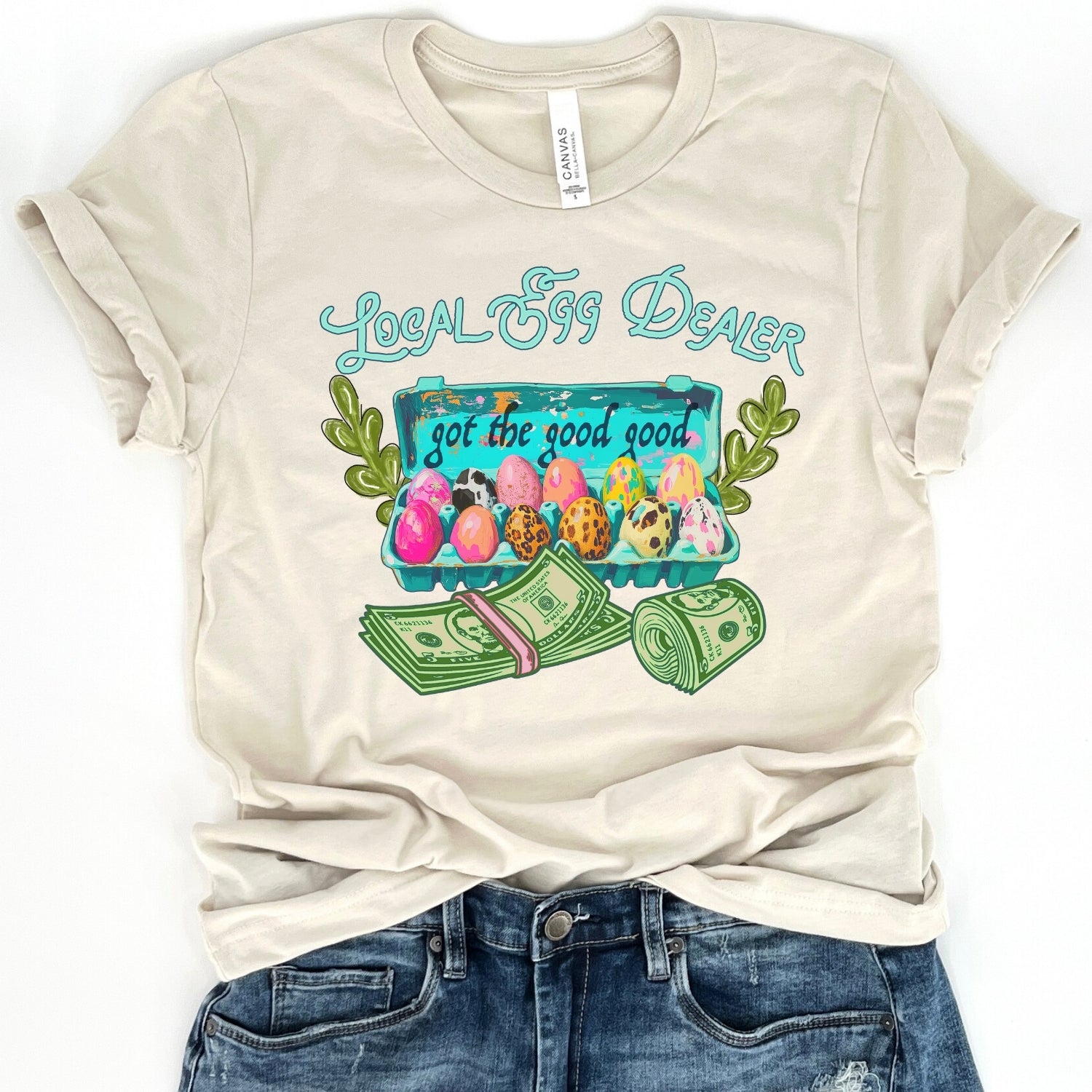 Beige t-shirt with 'Local Egg Dealer' graphic design on a white background