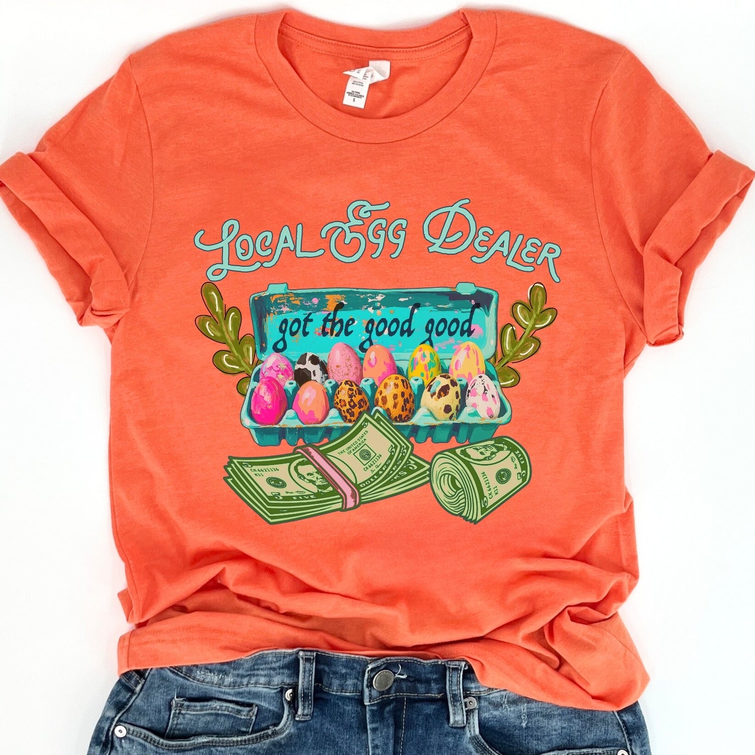 Orange t-shirt with 'Local Egg Dealer' graphic design on a white background