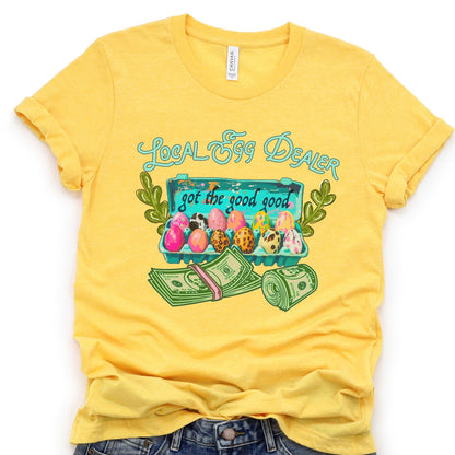 Yellow t-shirt with 'Local Egg Dealer' graphic design on a white background