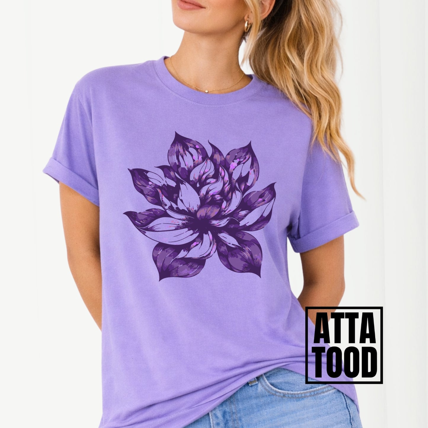 Purple t-shirt with a large purple floral design worn by a person, with 'ATTA TOOD' branding.
