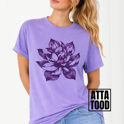 Purple t-shirt with a large purple floral design worn by a person, with 'ATTA TOOD' branding.