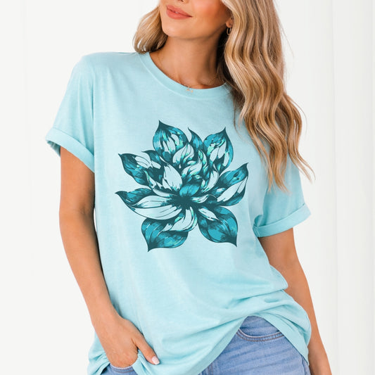 Light blue t-shirt with a large teal floral design worn by a person on a white background