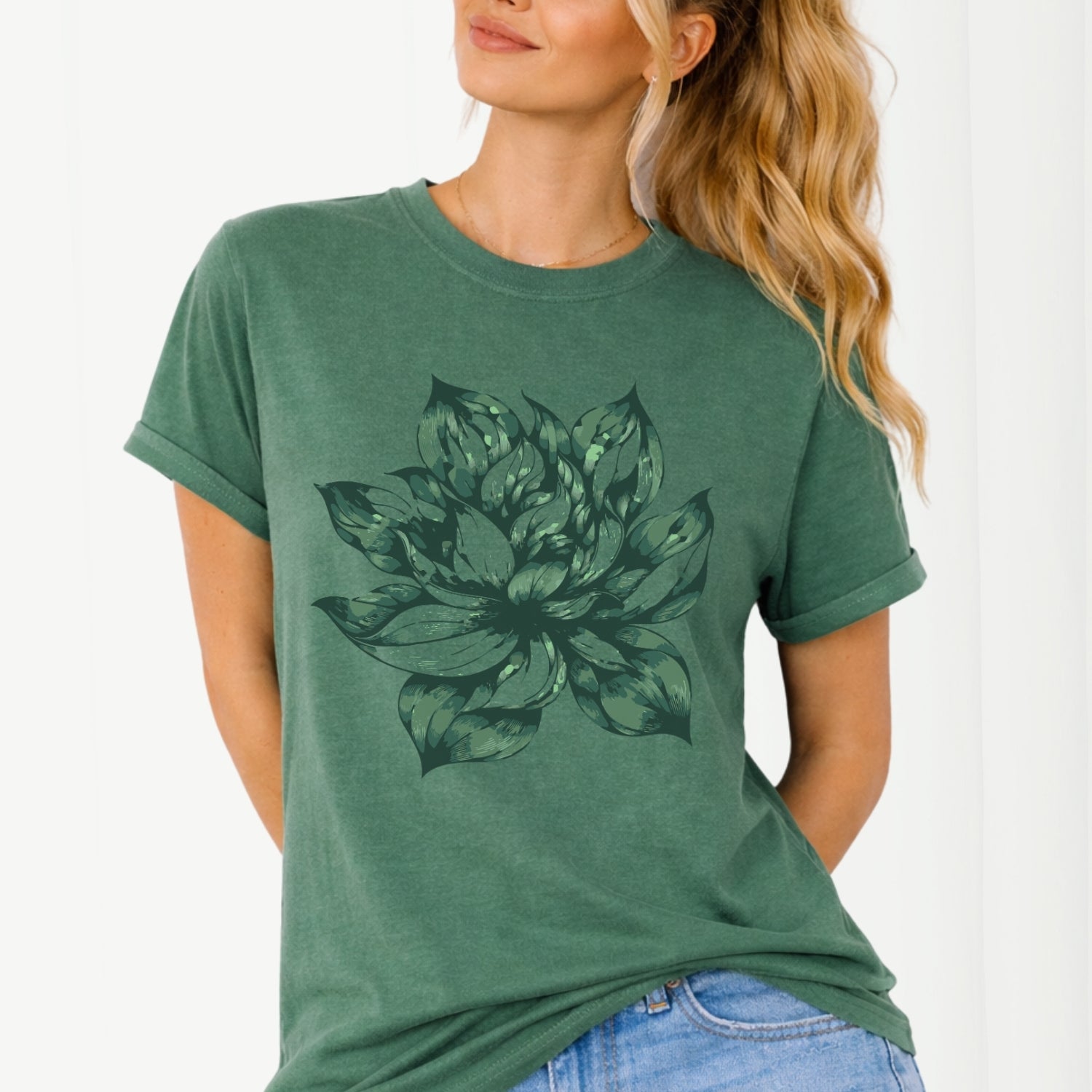 Woman wearing a green t-shirt with a lotus flower design on a white background