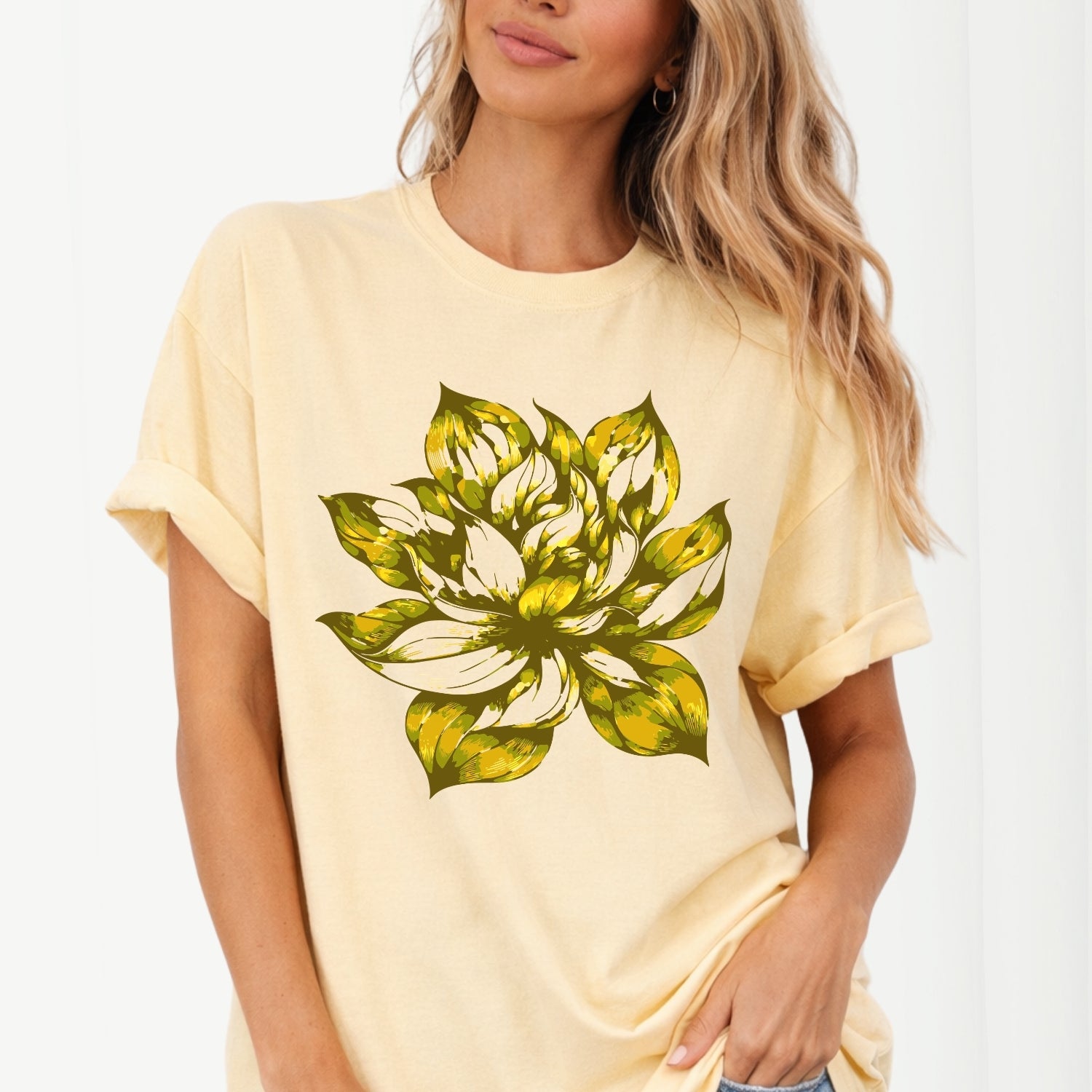 Woman wearing a yellow t-shirt with a greenish yellow  floral design on a white background